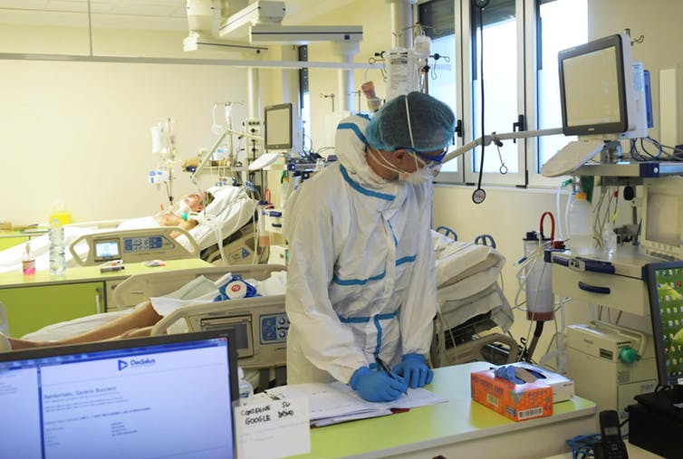 Doctors and nurses care for patients in the intensive care department of the Vizzolo Predabissi Hospital. Milan, Italy, March 24 2020. EPA-EFE/Andrea Canali